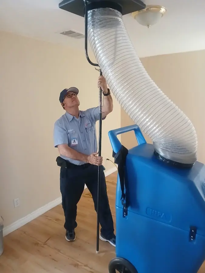 Furnace Tune-Up technician using HEPA equipment in Hampton